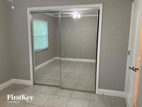 an empty room with a sliding glass closet