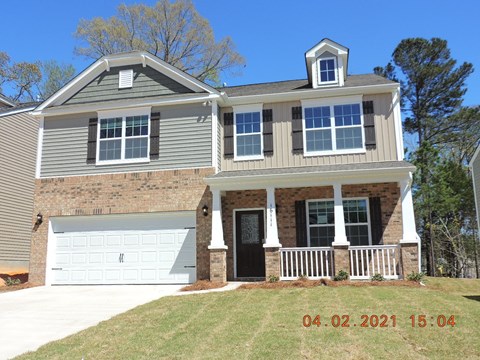 a front view of a house with a white garage door