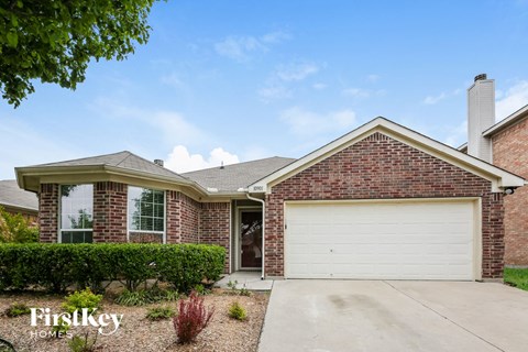 a home with a white garage door in front of it