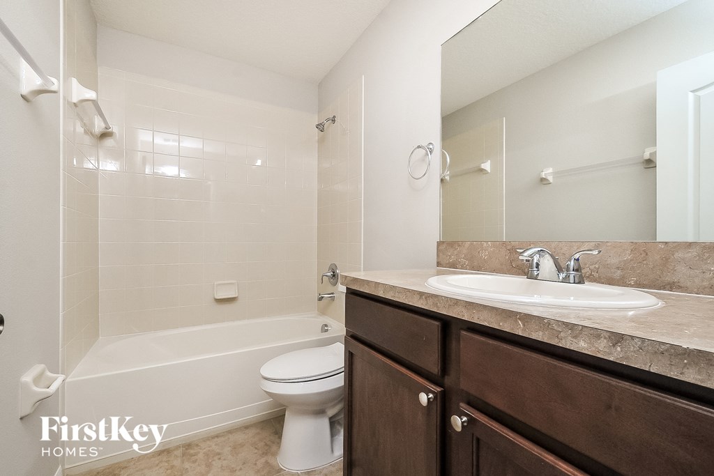a bathroom with a sink and a toilet and a bath tub