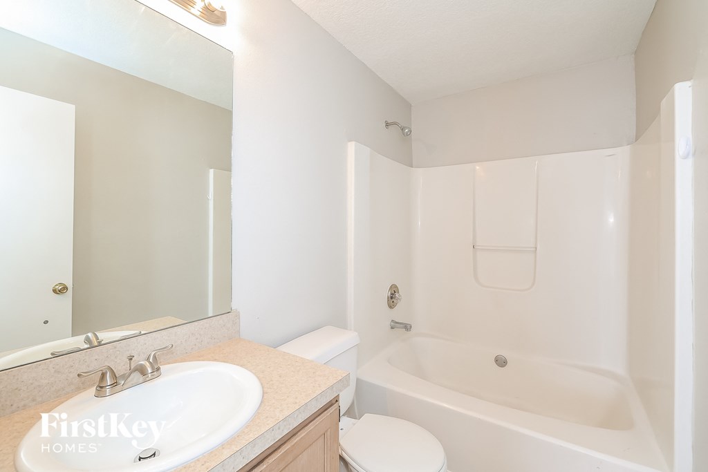 a bathroom with a sink and a tub and a toilet