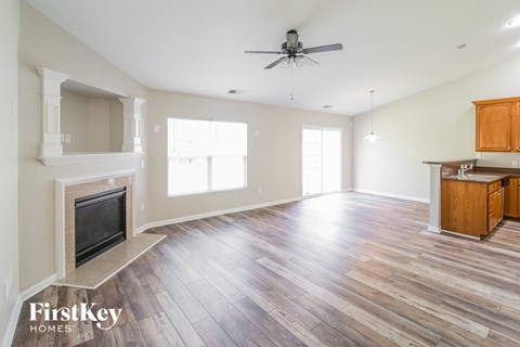 a living room with a fireplace and wooden floors
