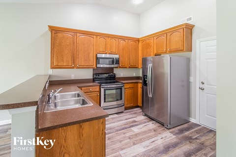 a kitchen with wooden cabinets and stainless steel appliances