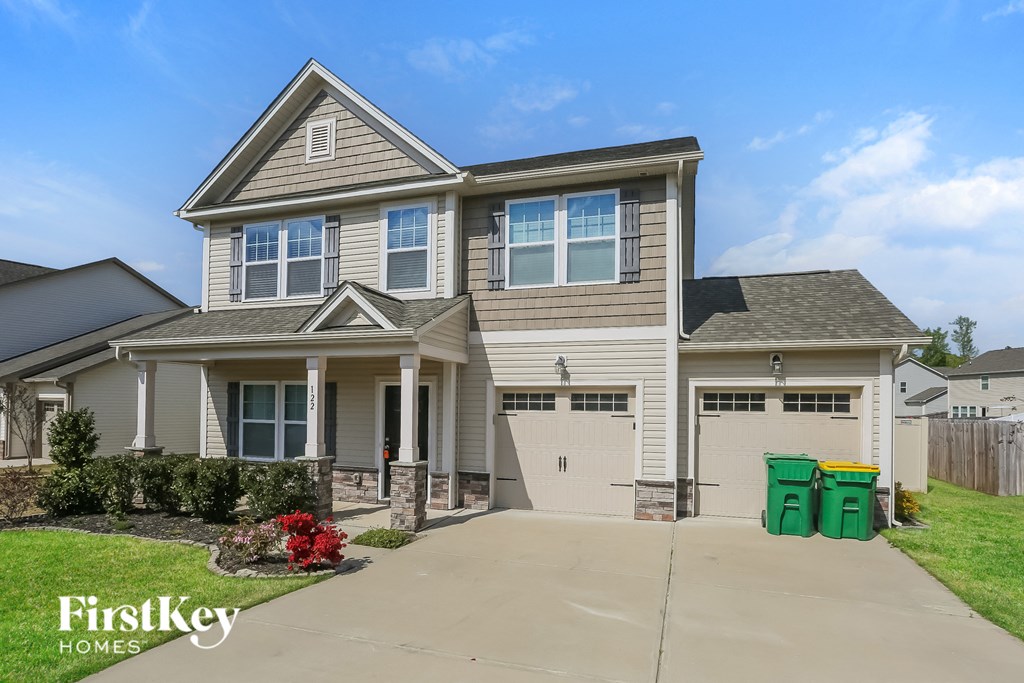 A two-story house with a garage is for sale by FirstKey Homes.