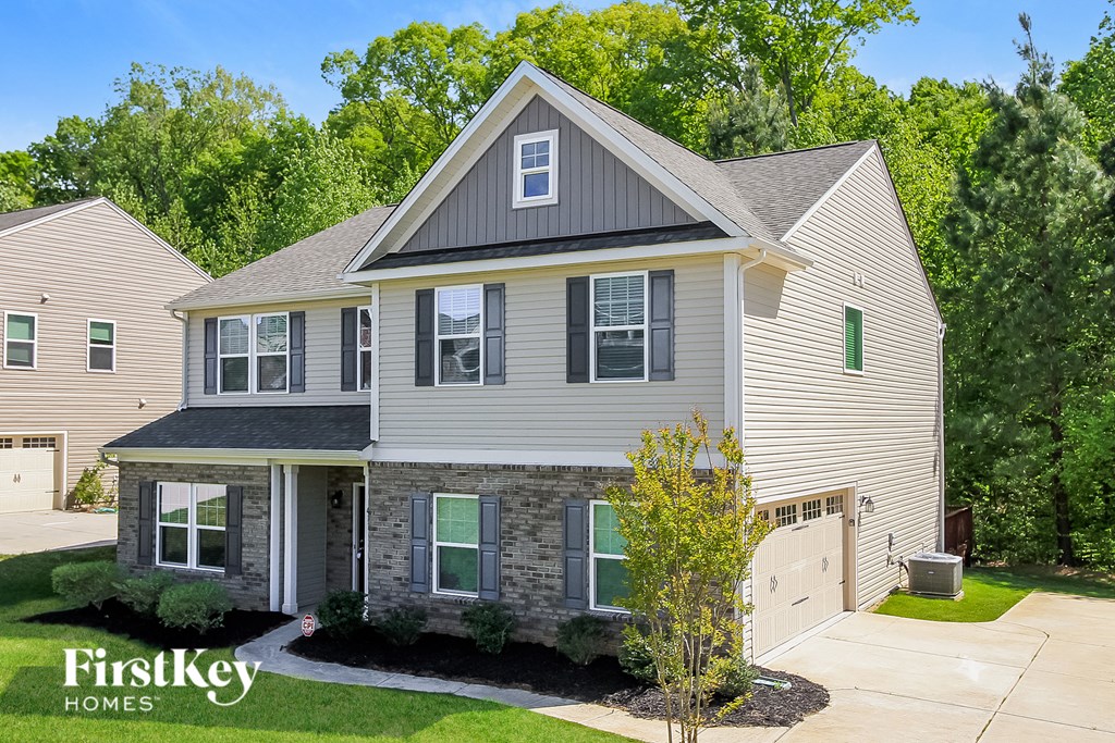 a white house with a gray roof and a garage