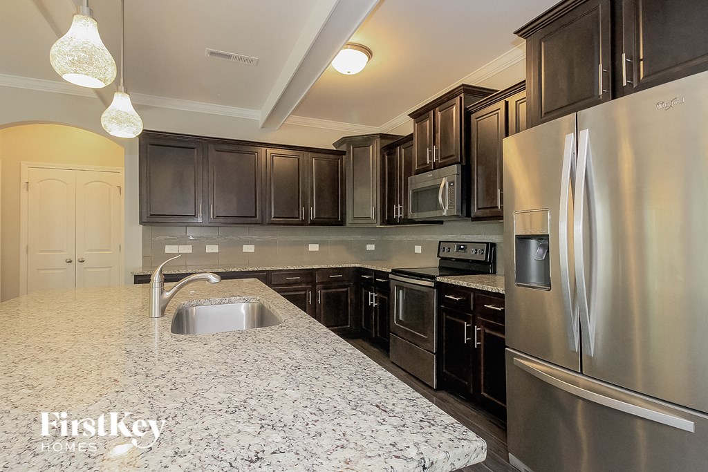 a kitchen with stainless steel appliances and granite counter tops