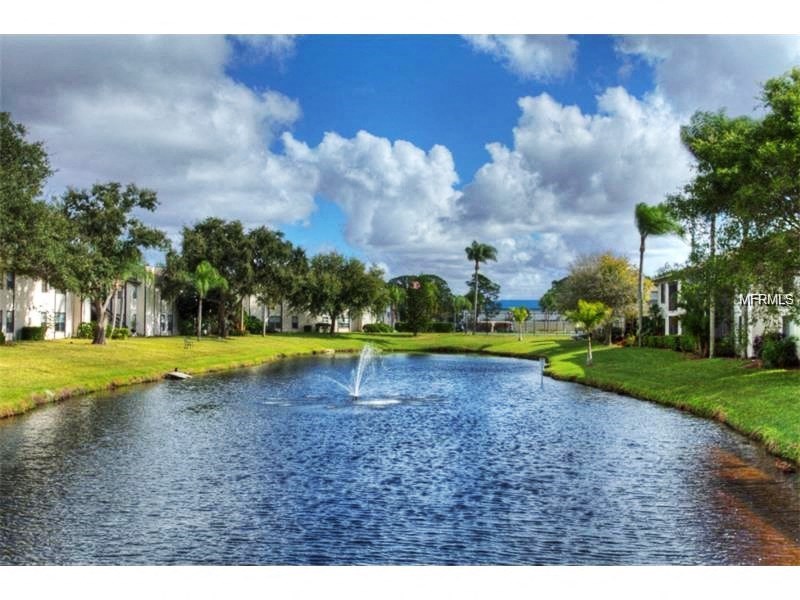 a large pond with a fountain in the middle of it