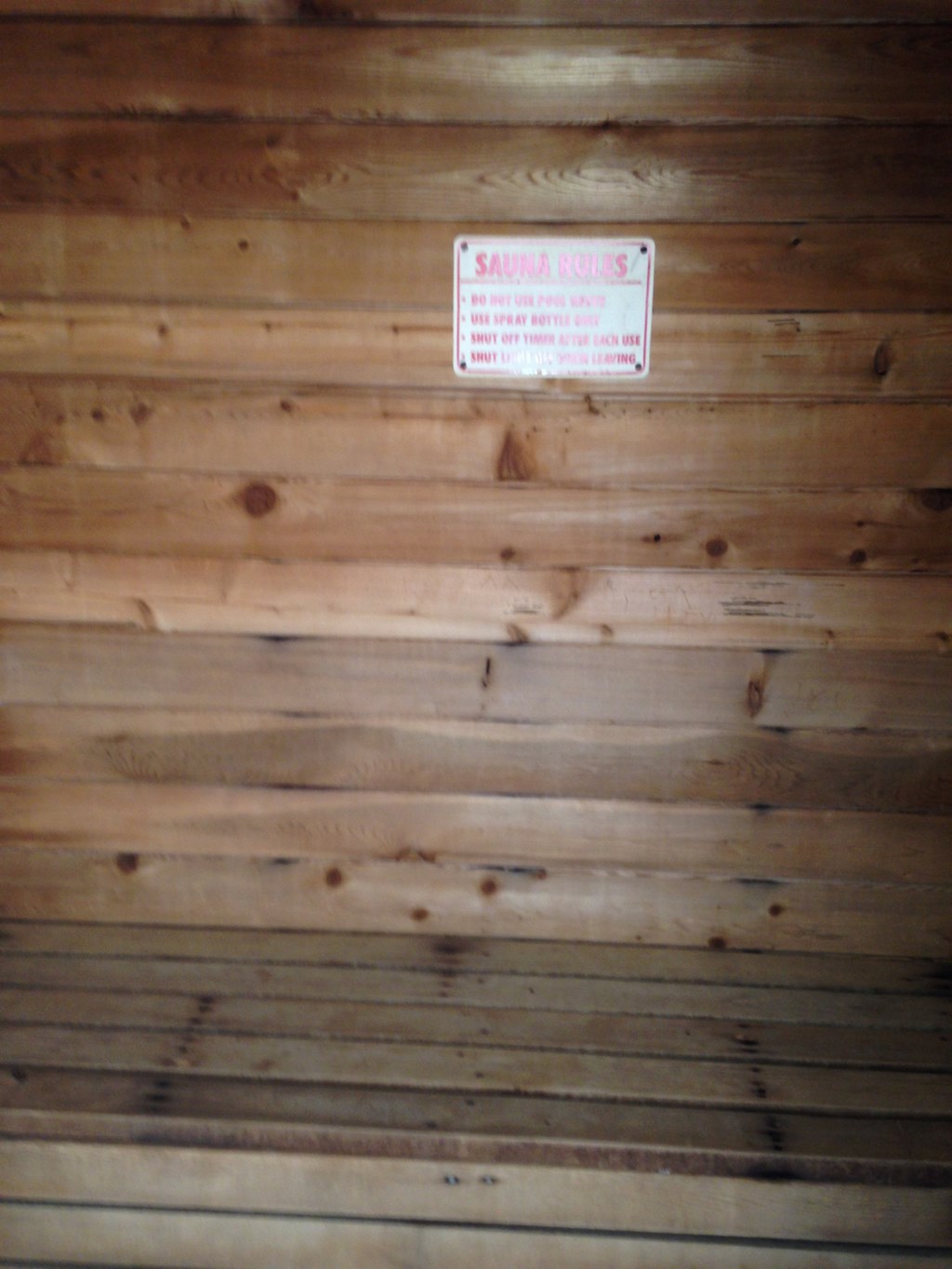 a sign on the wall of a wooden ceiling