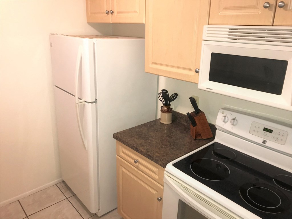 a kitchen with a stove and a refrigerator