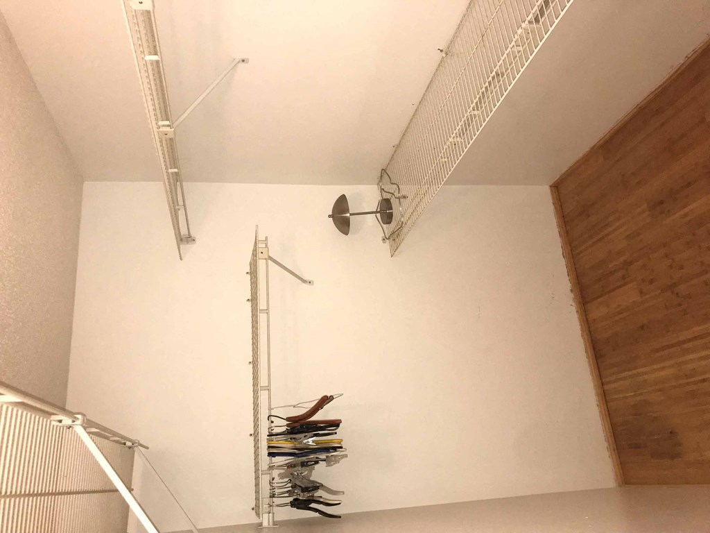 a closet in a room with hooks on the wall