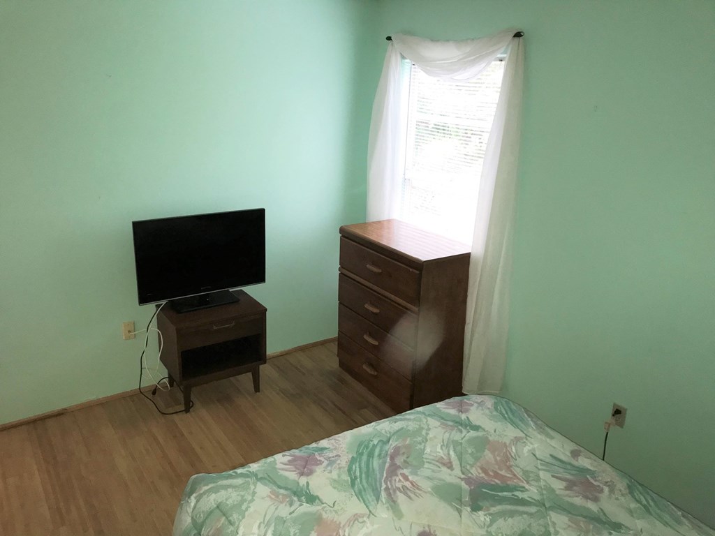 a bedroom with a bed and a tv