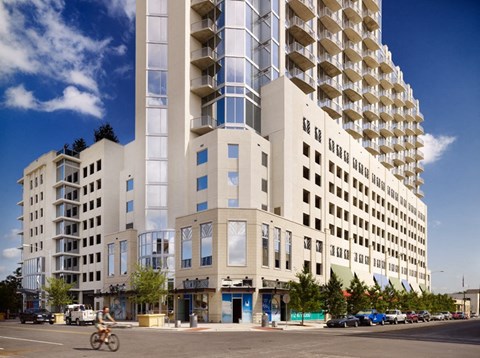 A tall building with many windows and balconies is in the background.