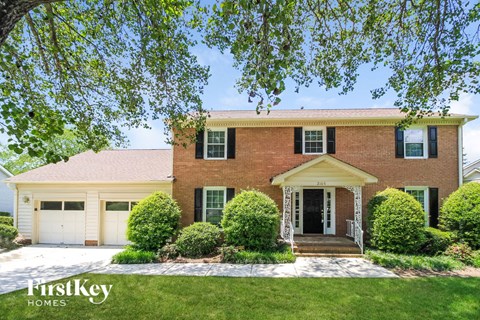 a large brick house with a white garage door