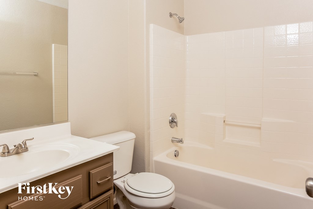 a bathroom with a toilet and a tub and a sink