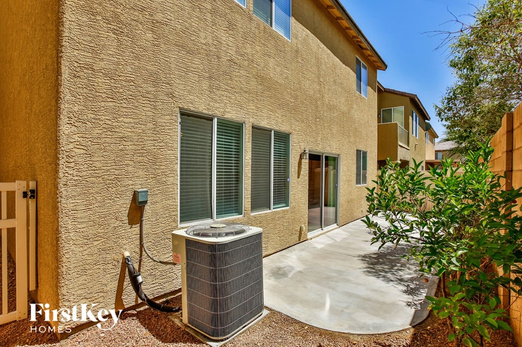a side view of a building with a patio and a water heater