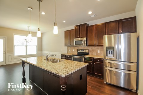 a kitchen with stainless steel appliances and granite counter tops