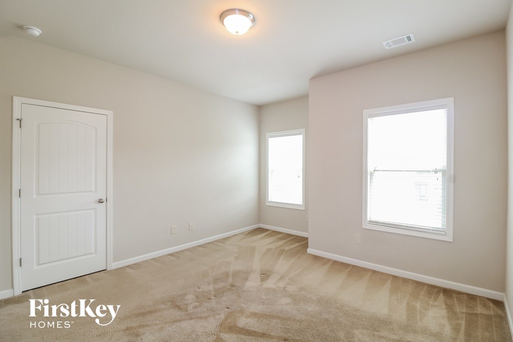a bedroom with a white door and a window
