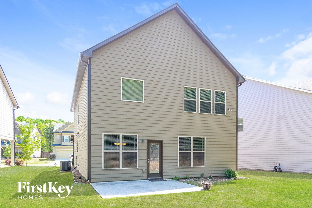 front view of a house with a driveway and grassy yard