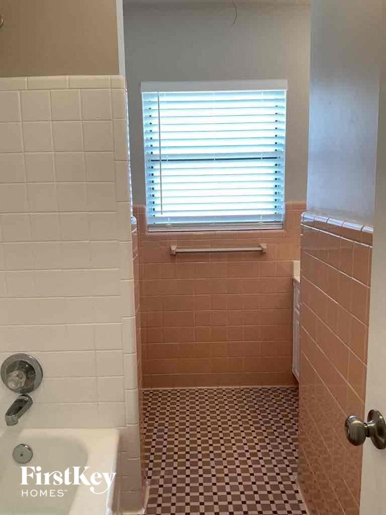 a bathroom with a tub and a window in it