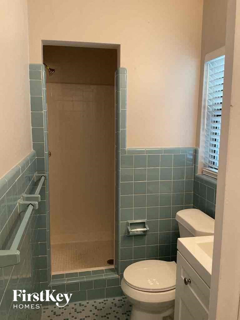 a small bathroom with a toilet and a shower