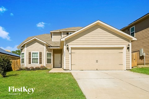 a beige and brown house with a garage door