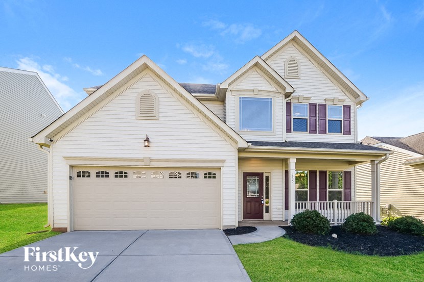a white house with a driveway in front of it