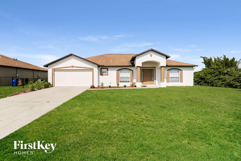 A large house with a brown roof and a white garage door.