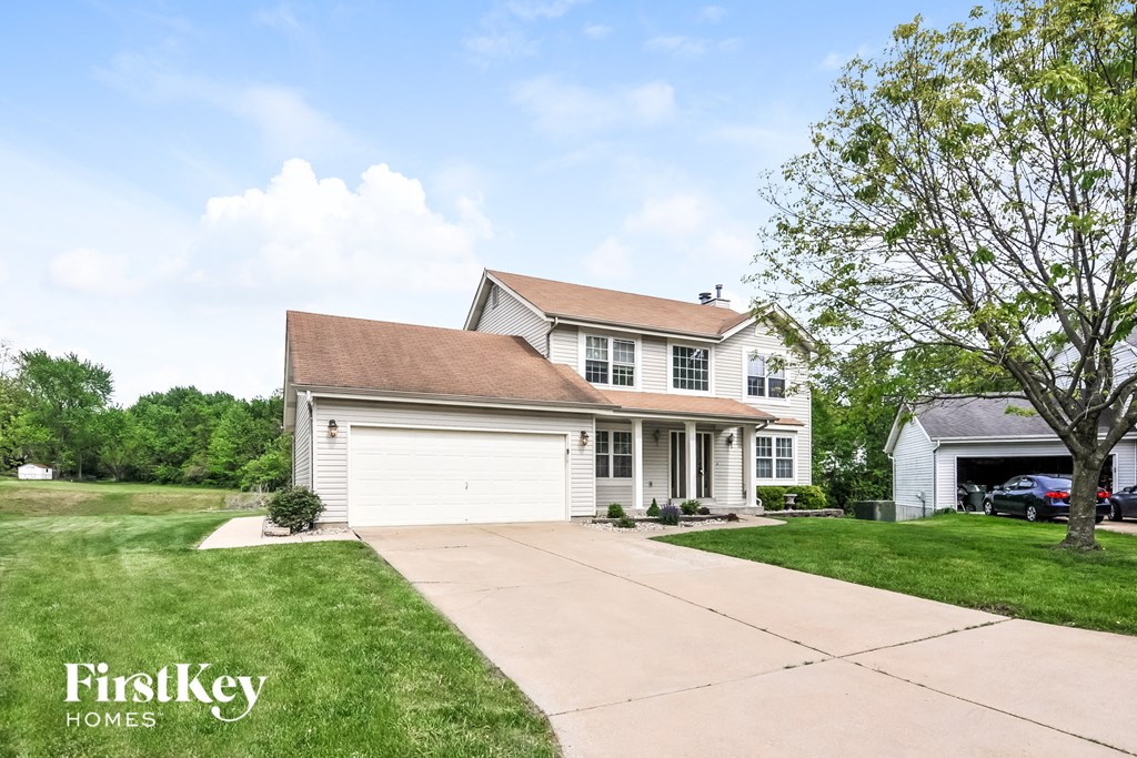 a white house with a garage and a driveway