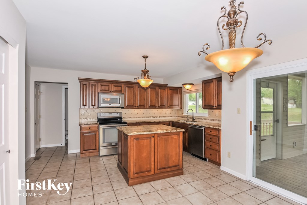a kitchen with wooden cabinets and stainless steel appliances