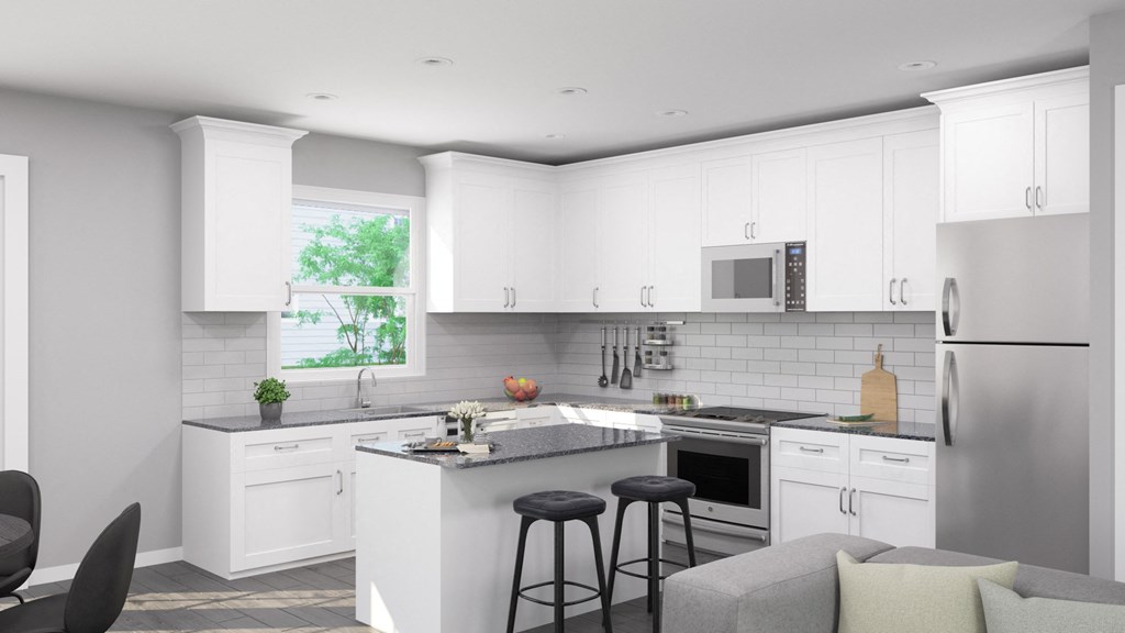 a white kitchen with white cabinets and a counter top