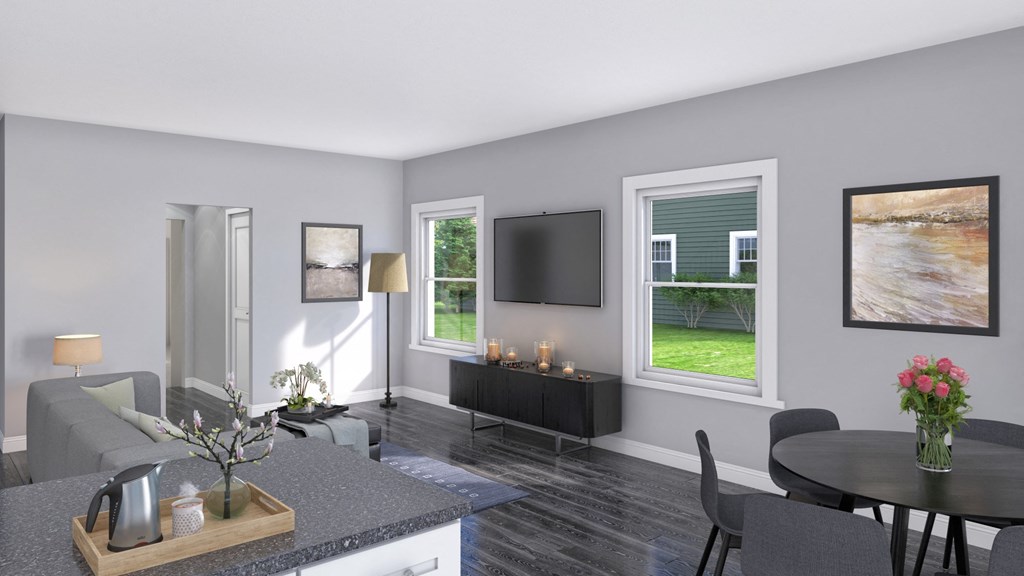 a living room and dining room with a table and a television
