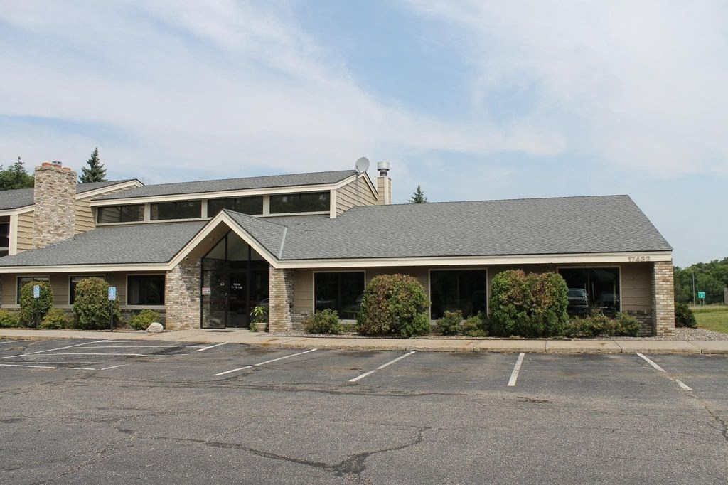 the front of a building with a empty parking lot