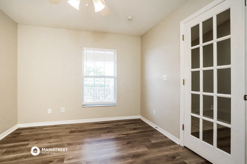 the living room of a new home with white walls and wood flooring