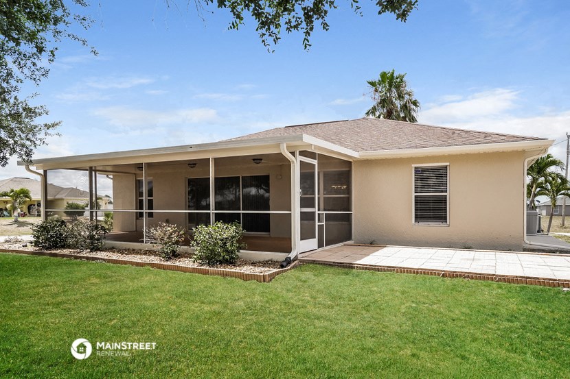a small house with a lawn and a porch