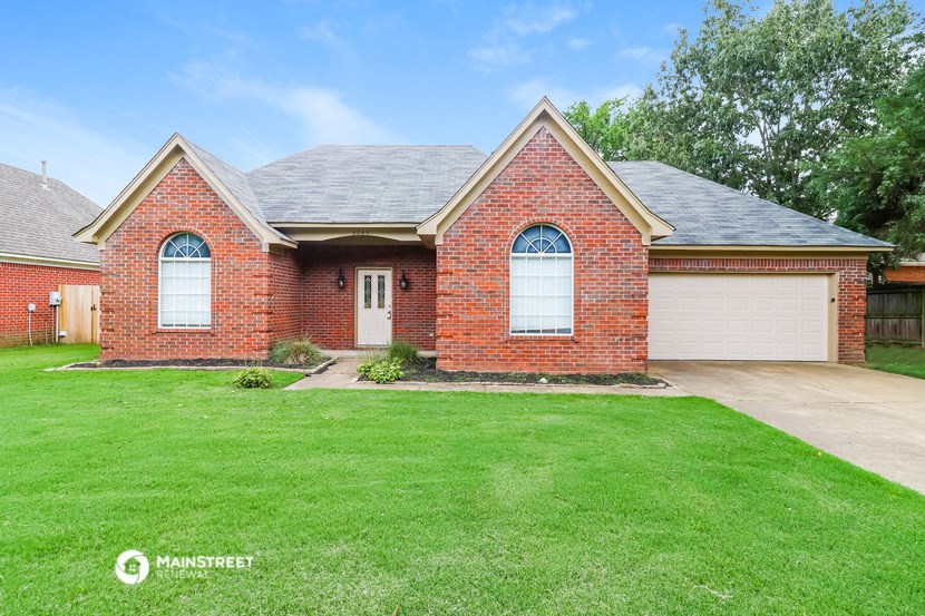 a brick house with a lawn in front of it