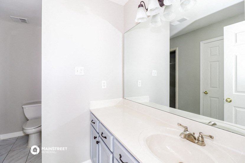 a bathroom with a sink and a mirror and a toilet