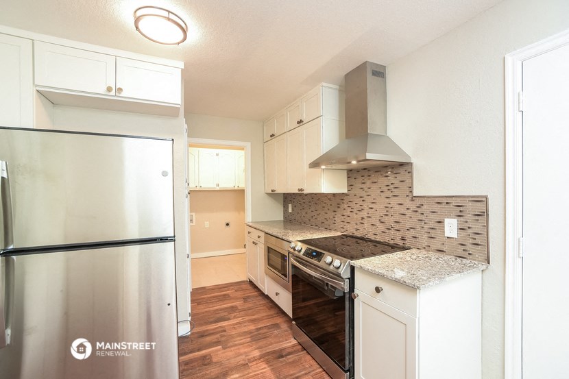 a kitchen with stainless steel appliances and white cabinets