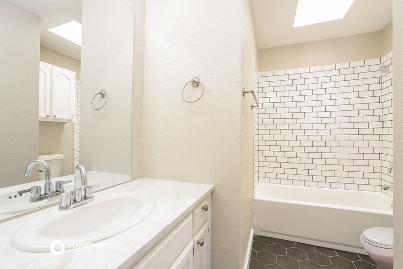 a bathroom with a sink and a toilet and a tub