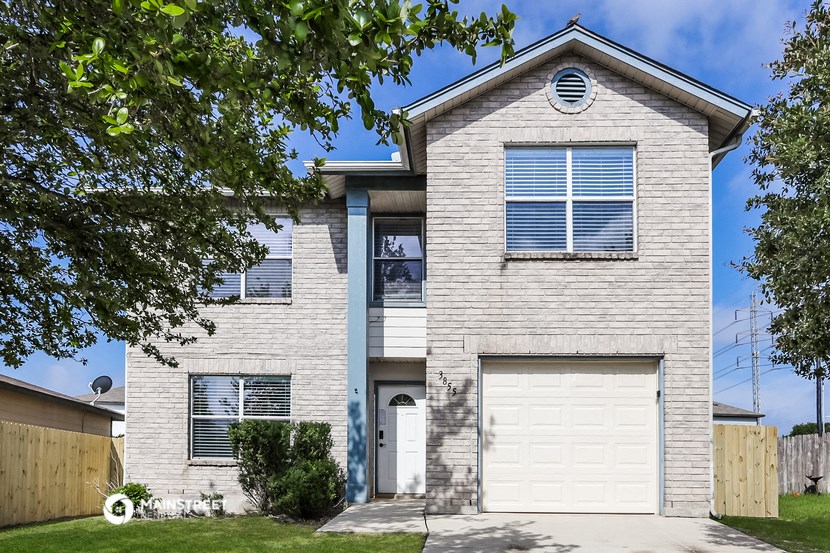 a white brick house with a white garage door