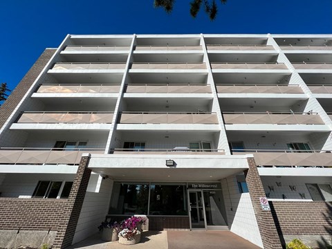 The entrance to a building with a sign that reads "The Willowbrook".