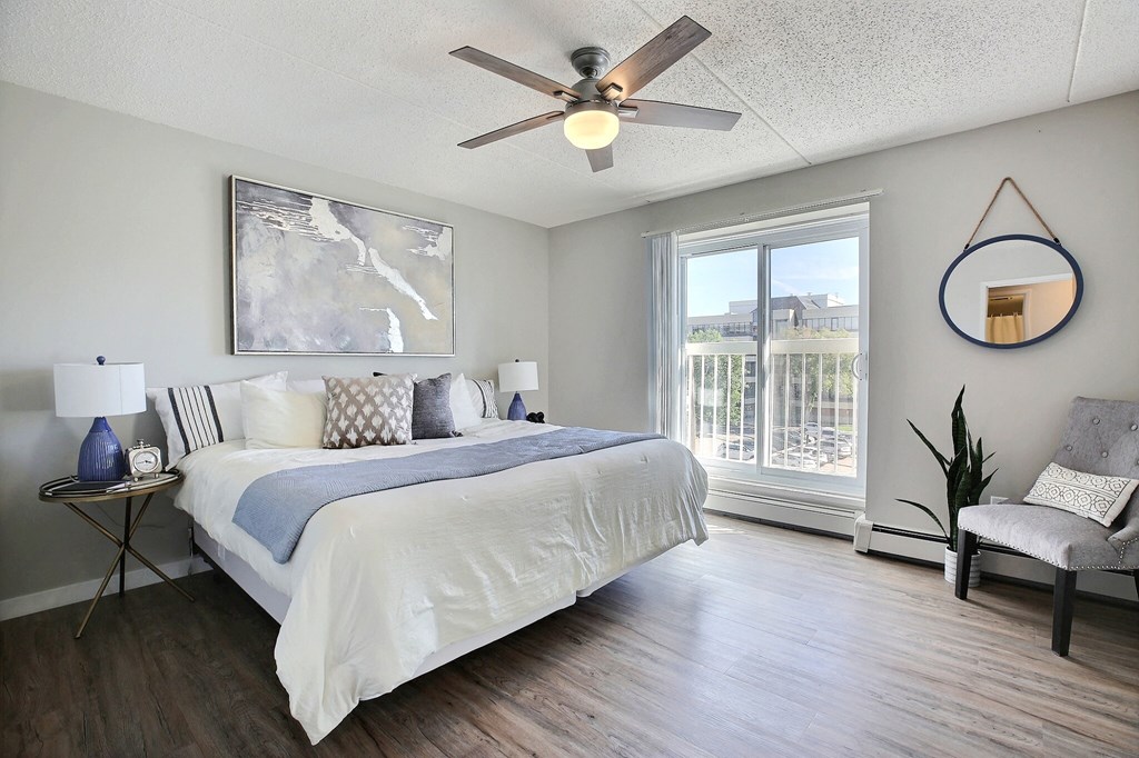 a bedroom with a large bed and a ceiling fan