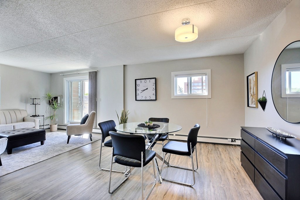 a living room with a glass table and chairs