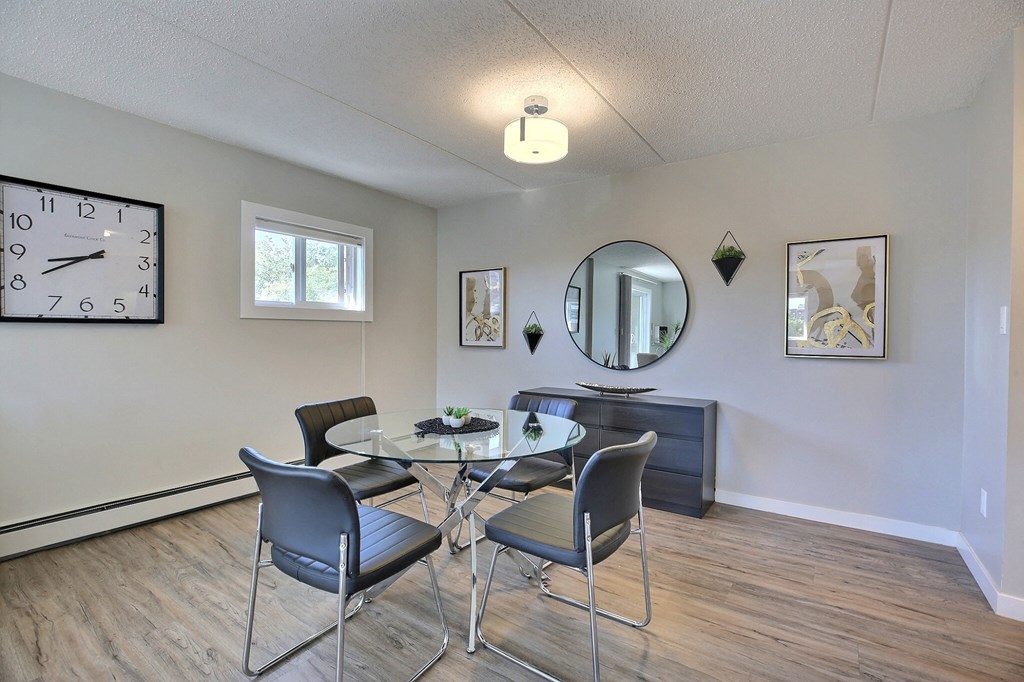 a dining room with a glass table and chairs