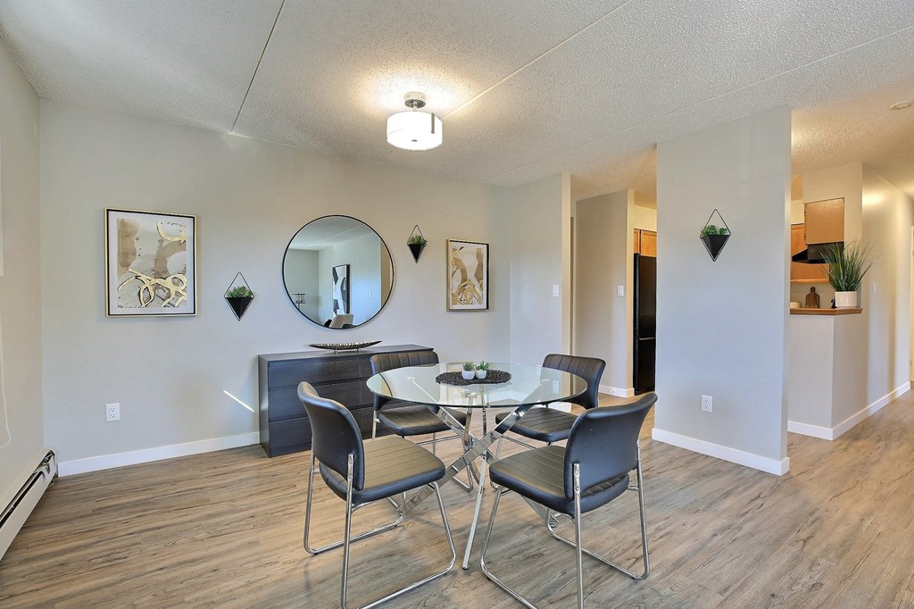 a dining room with a glass table and chairs