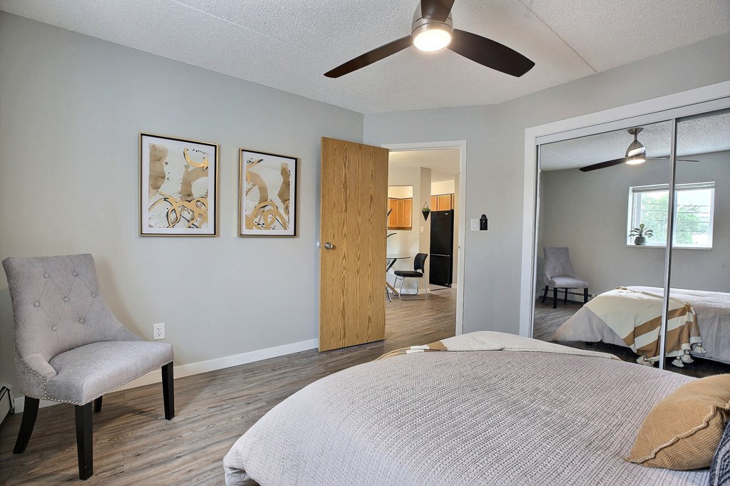 a bedroom with a bed and a ceiling fan