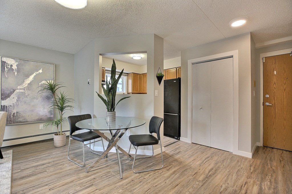 a dining room with a glass table and chairs