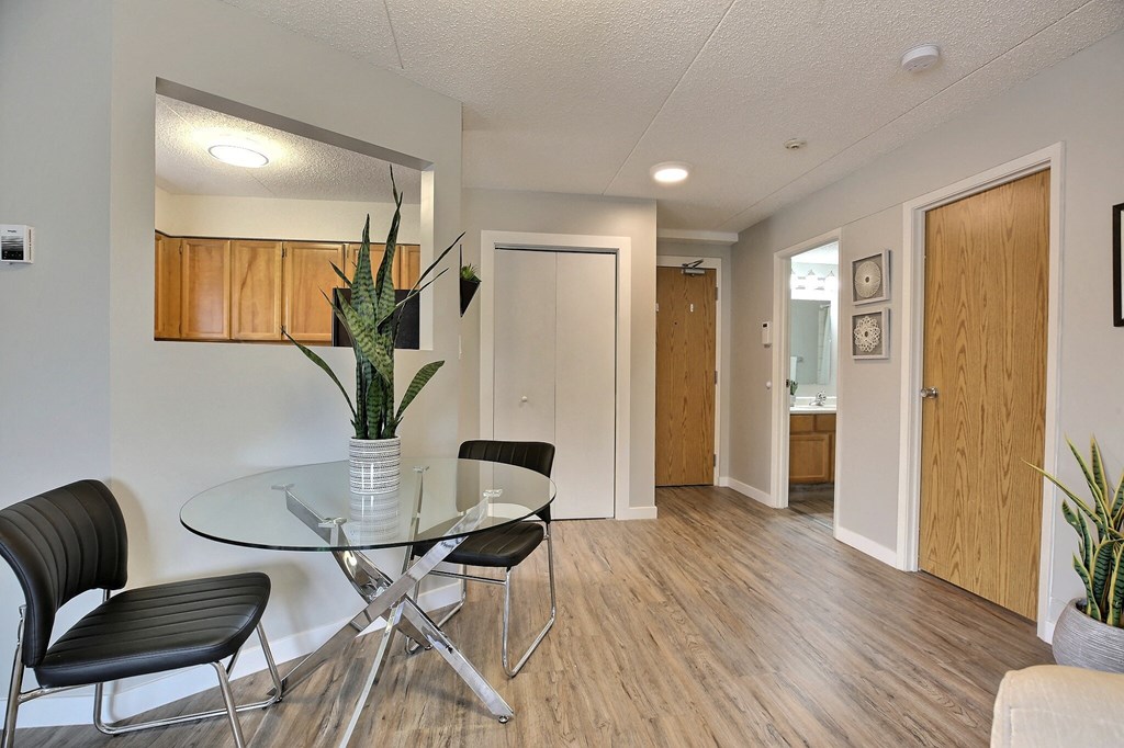 a dining room with a glass table and chairs