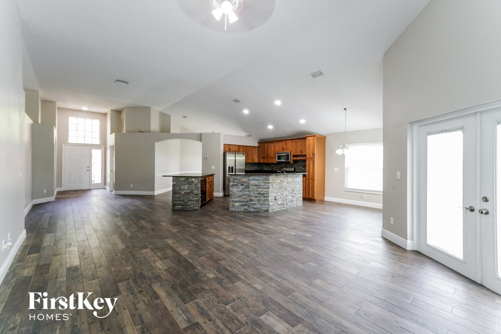 the living room and kitchen are open to the dining and kitchen area