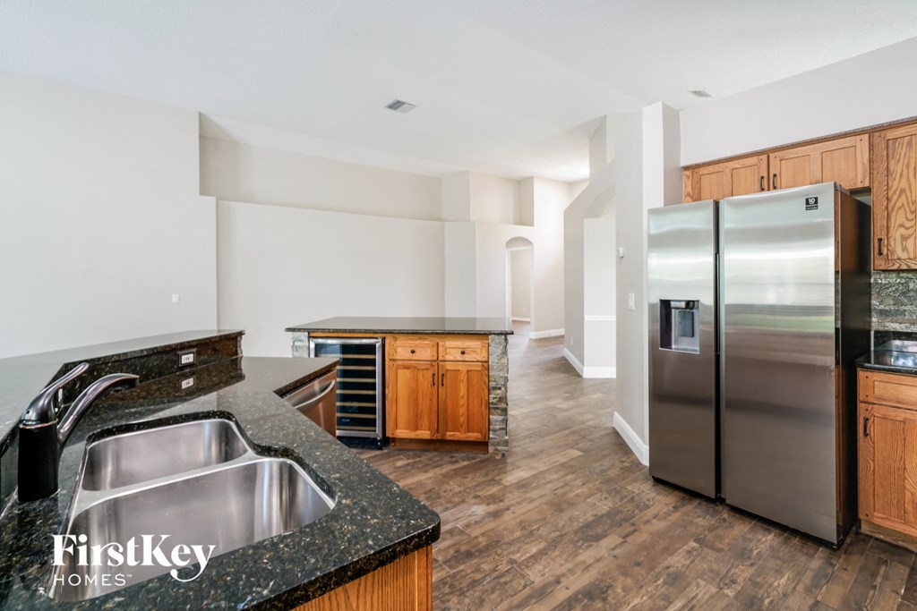 a kitchen with a stainless steel refrigerator and a sink