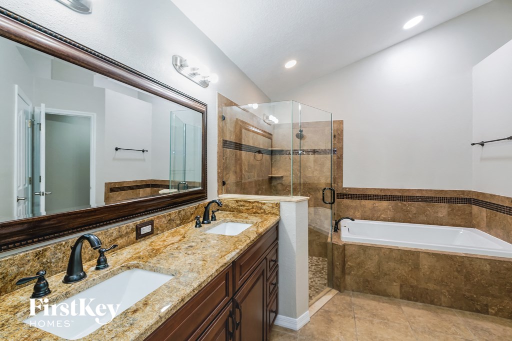 two sinks in a bathroom with a tub and a shower